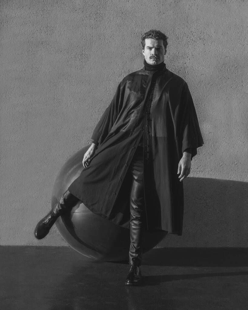 a man standing next to a large ball