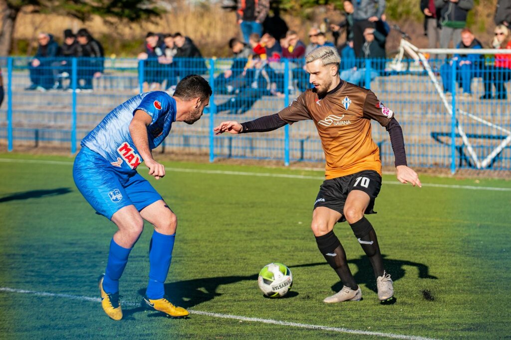 Photo Of Man Playing Soccer During Daytime,blue uniform