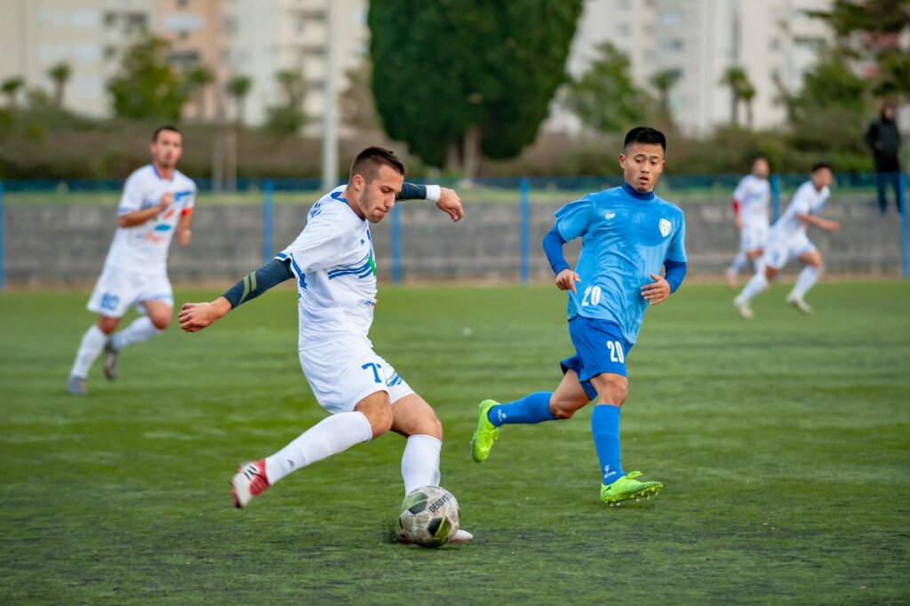 Man Wearing Blue Shirt Looking on Ball,blue uniform