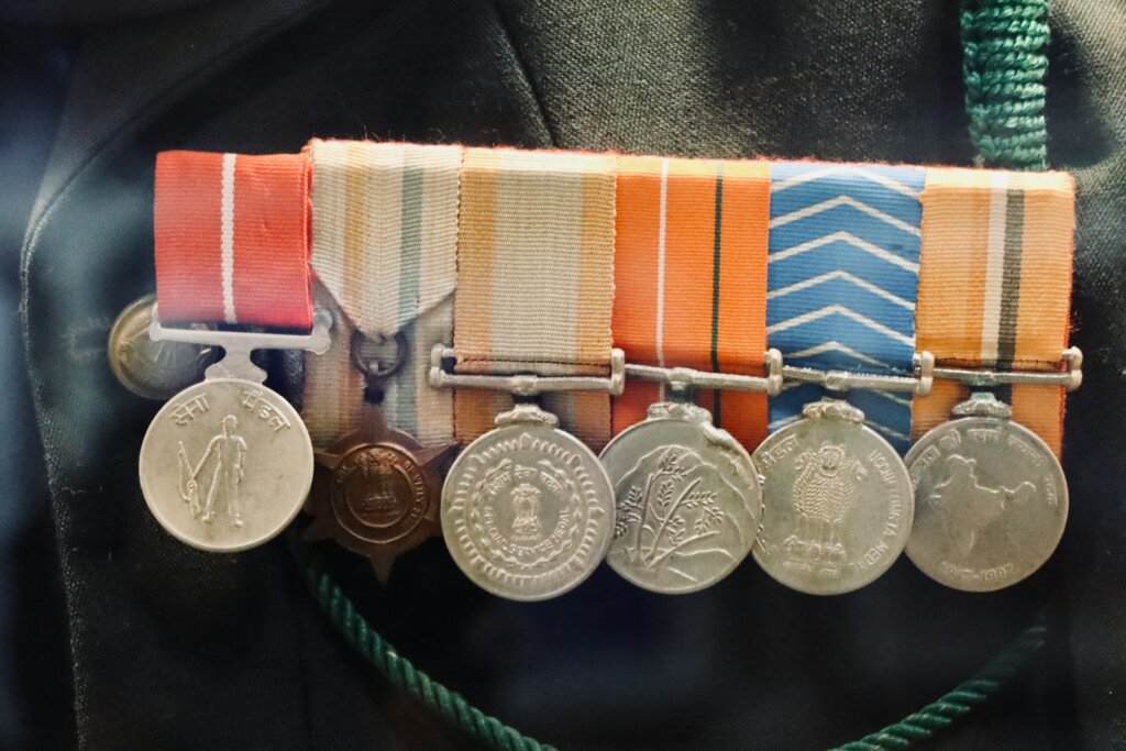 A man wearing a uniform with medals attached to his belt