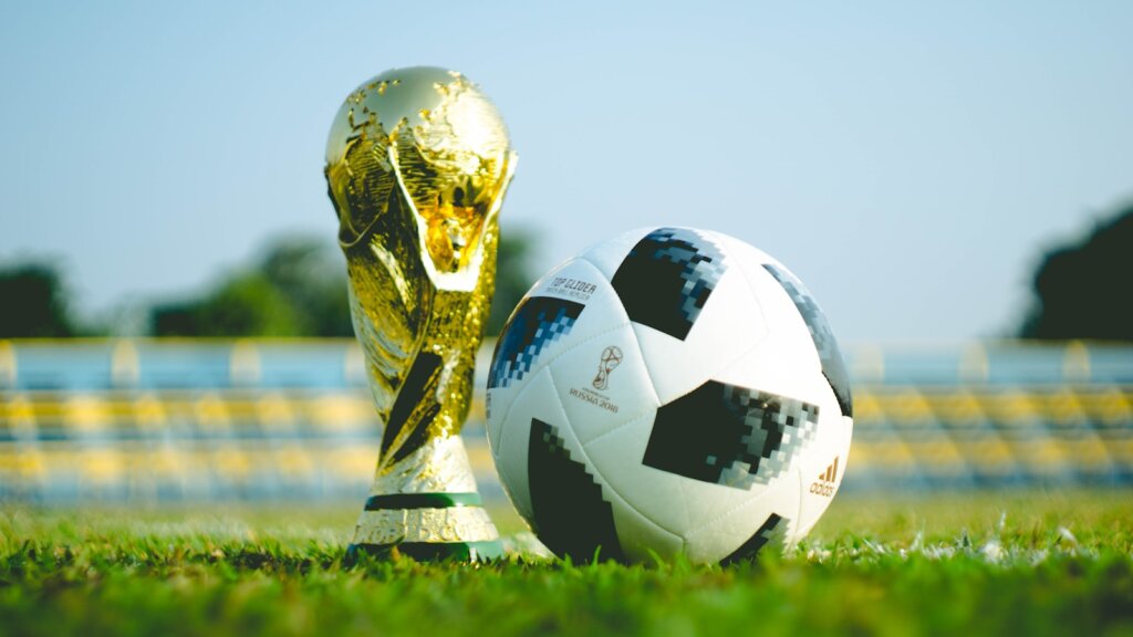 gold-colored trophy and soccerball,world cup