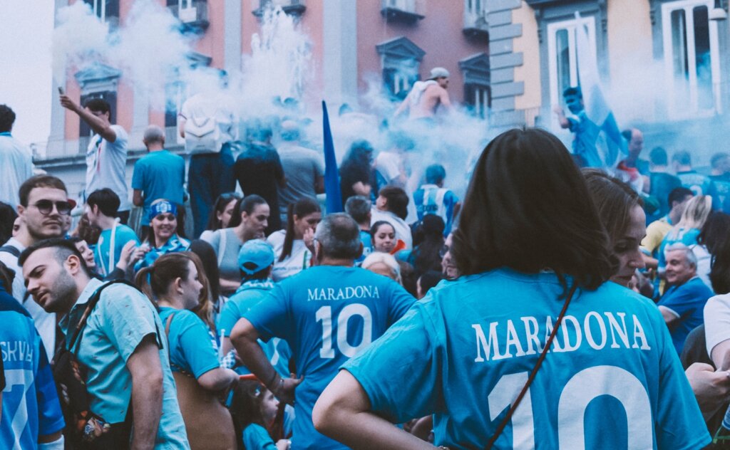 a group of people standing around each other,Maradona napoli