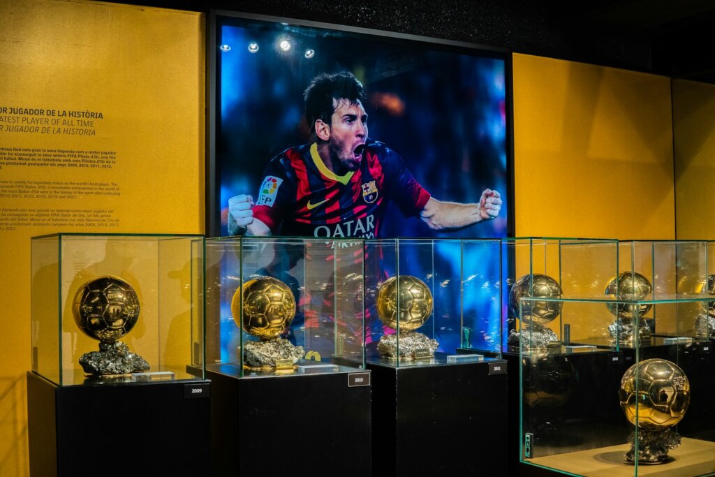 a person standing behind trophies,fc Barcelona