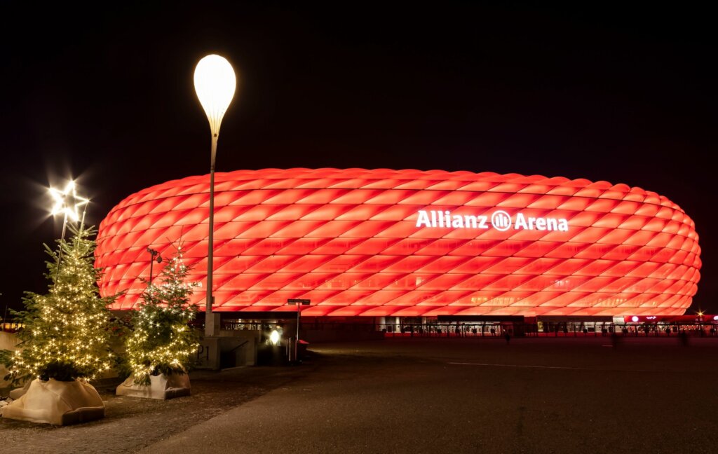 the allianz arena is lit up at night