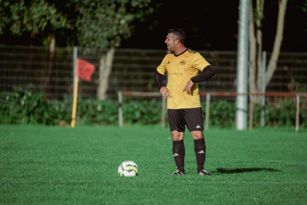 Man Playing Football on a Field