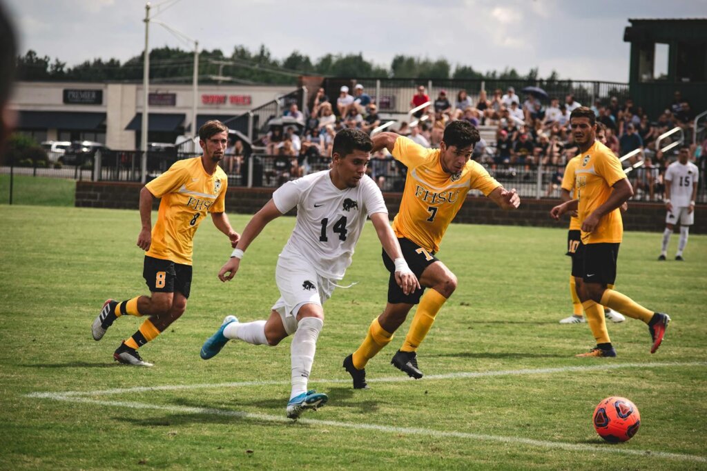 Exciting soccer match with players in motion and enthusiastic spectators.